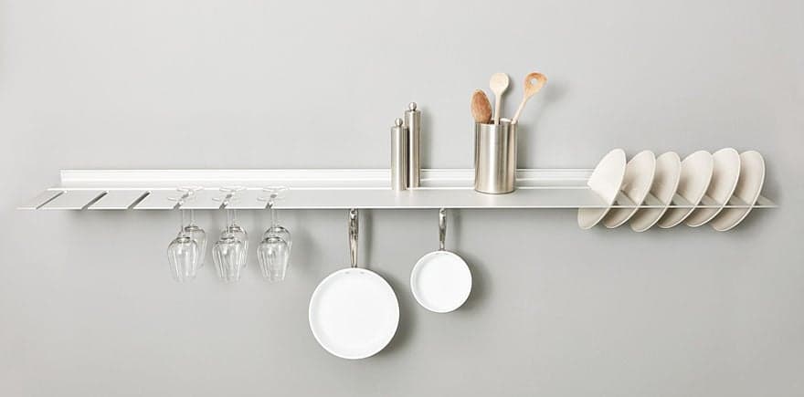 strackk with glasses , plates and pans
