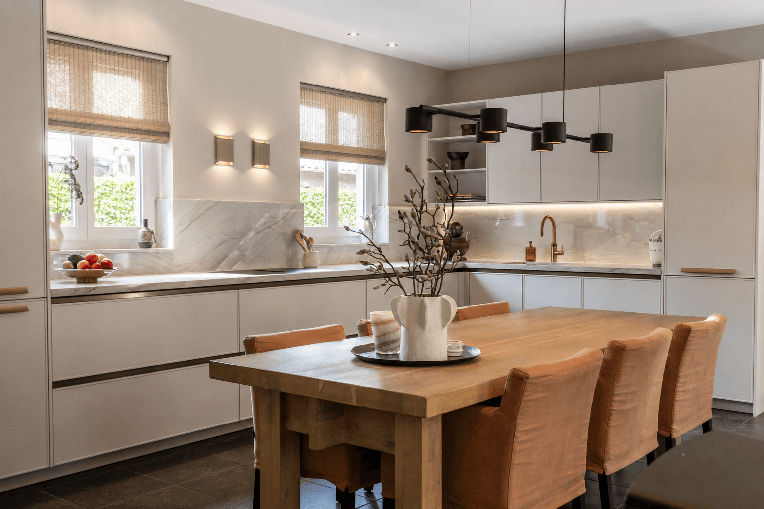 Beige hoekkeuken met eetkamertafel in het midden van de keuken